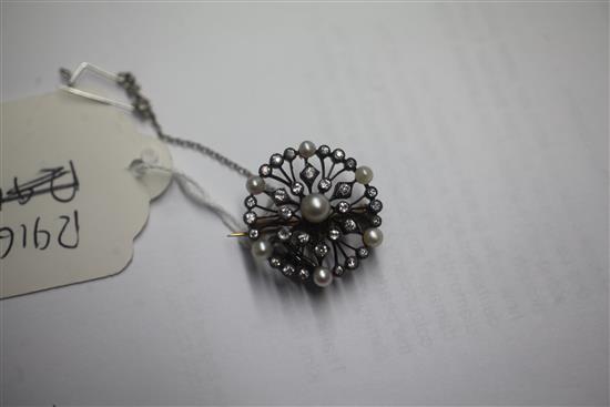 An early 20th century gold and silver, diamond and cultured pearl set openwork circular pendant brooch, 1.25in.